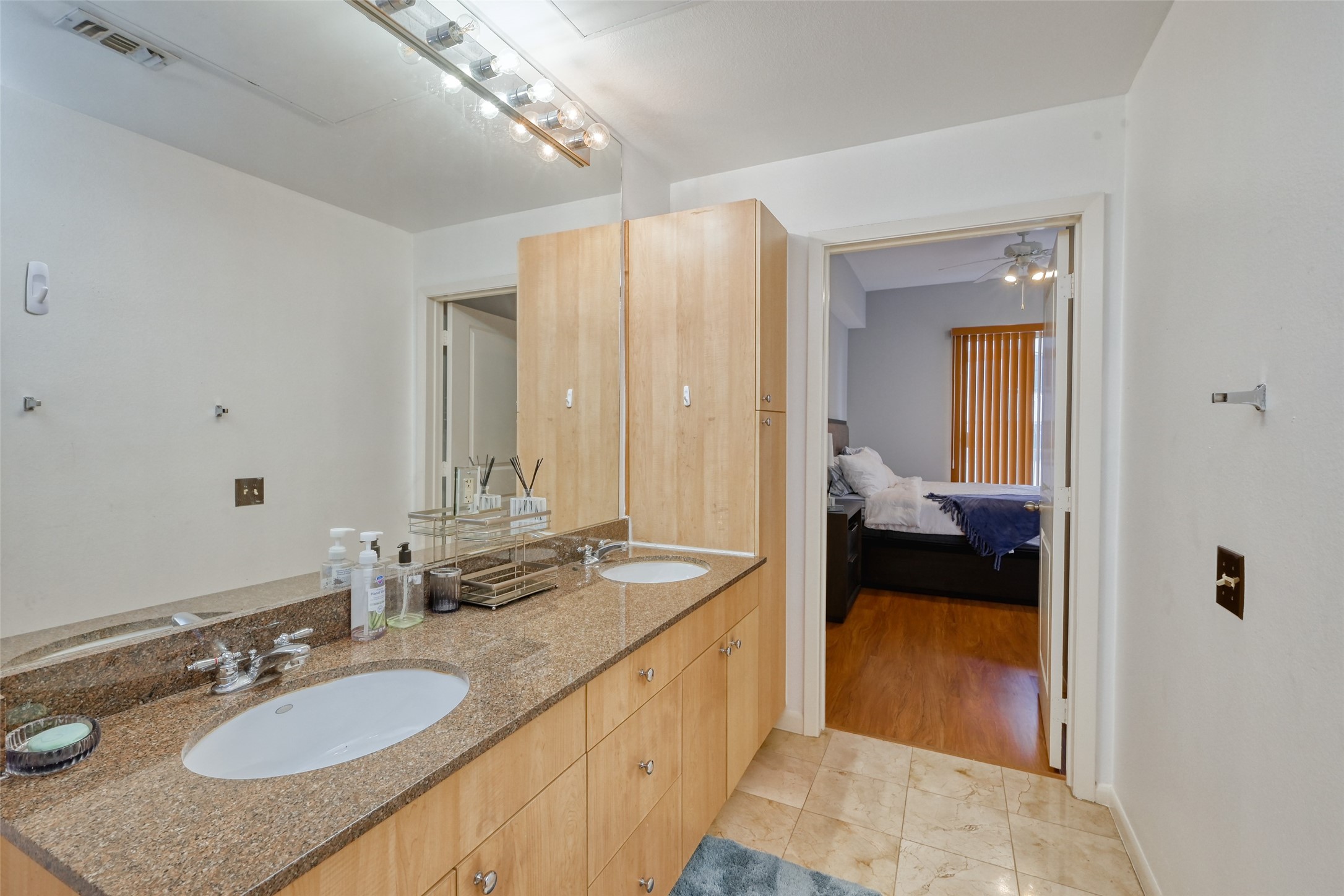 3505 Sage Road, Unit 1206 Houston, TX 77056 - Photo 41 of 50 a en suite bathroom with a granite countertop sink and a mirror