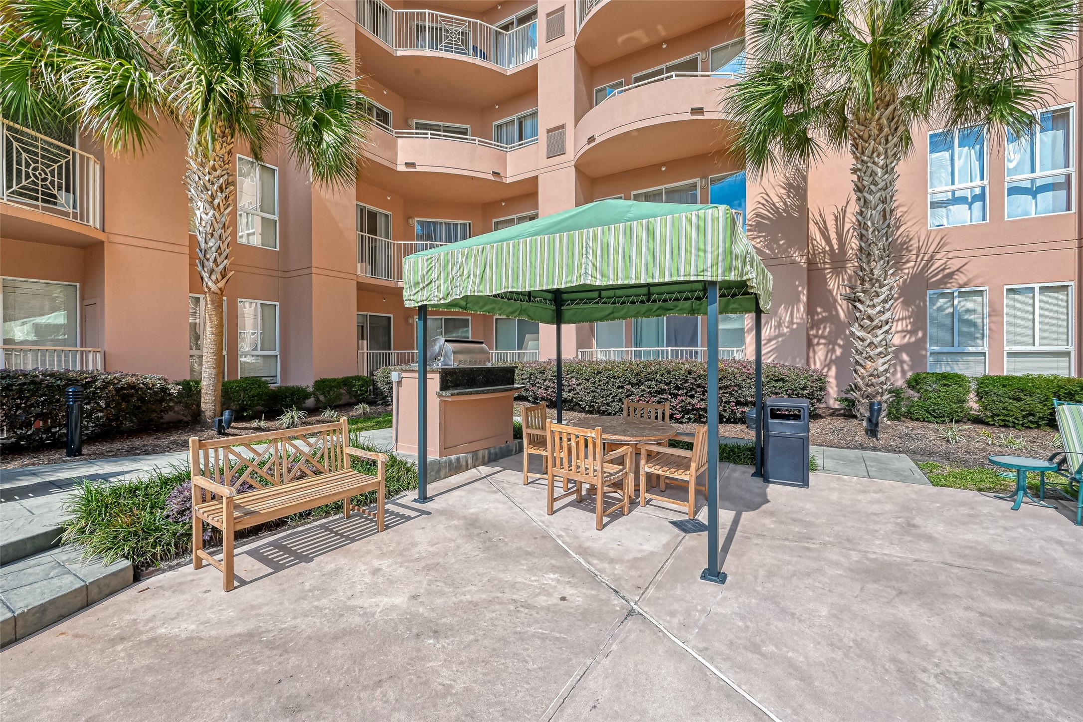 3505 Sage Road, Unit 1206 Houston, TX 77056 - Photo 46 of 50 a view of a patio with couches and table and chairs under an umbrella