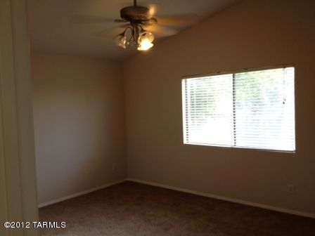 6096 South Nantac Rim Drive Tucson, AZ 85706 - Photo 5 of 5 an empty room with a window