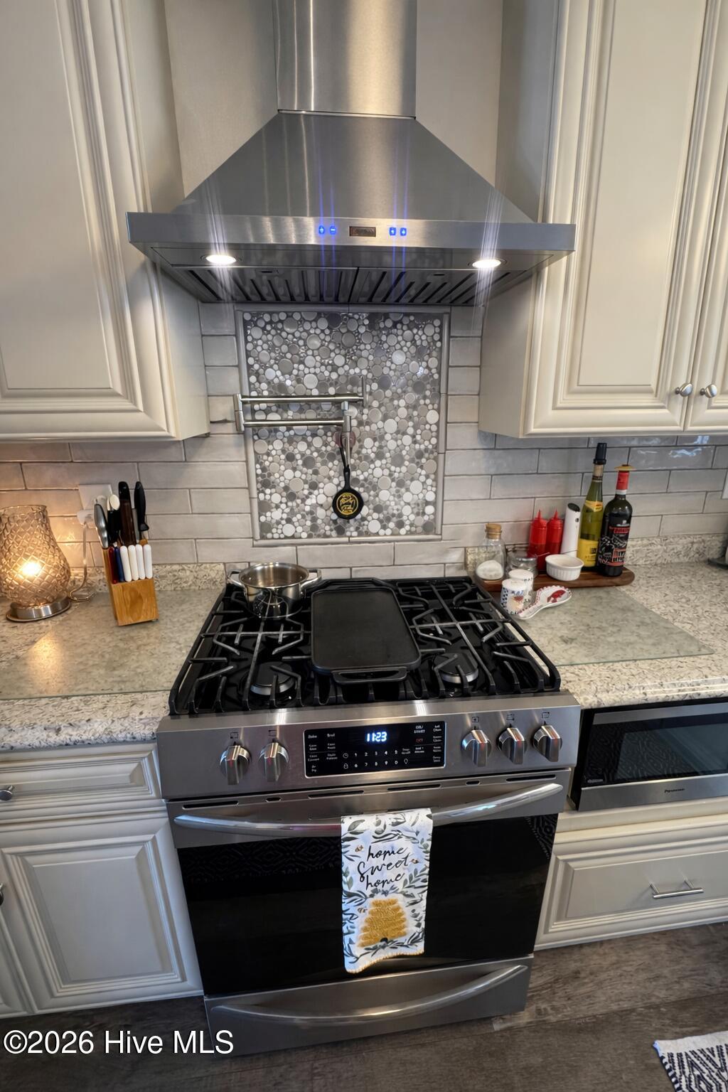 330 Cape Lookout Loop Emerald Isle, NC 28594 - Photo 18 of 50 Gas oven and cooktop with a grill top and hood with pot filler