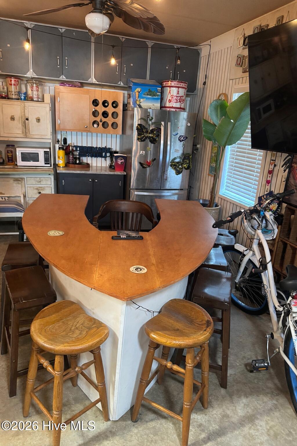 330 Cape Lookout Loop Emerald Isle, NC 28594 - Photo 34 of 50 IN downstairs a entertainment center with boat bar is negociable and has cabinets behind and extra refrigerator and dry bar with microwave and counter area for mixing drinks