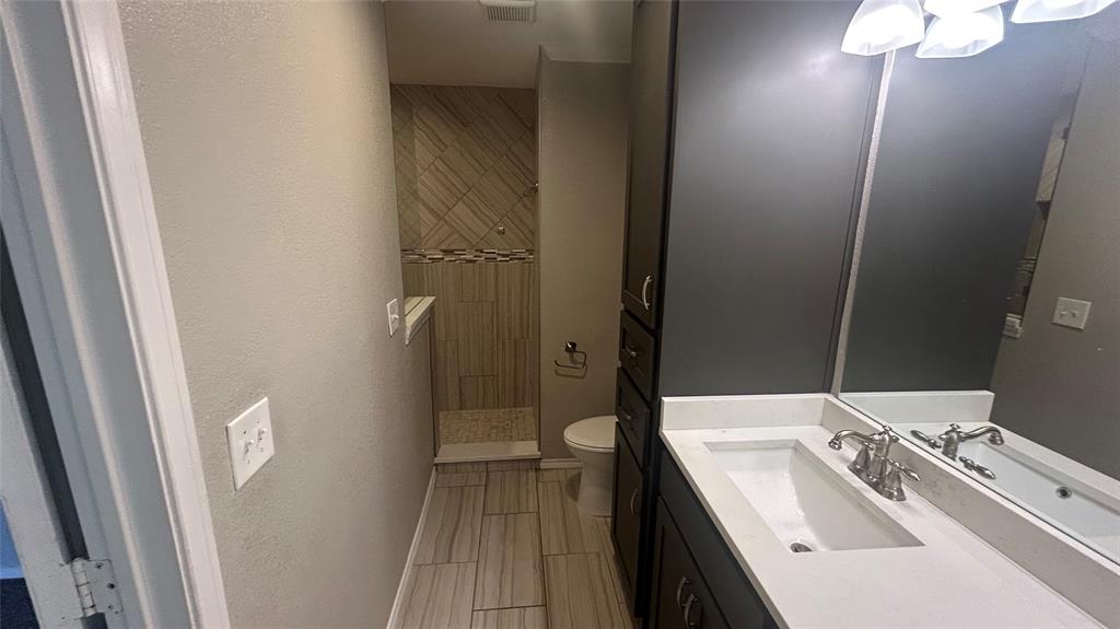 6705 Red Fox Trail Fort Worth, TX 76137 - Photo 11 of 15 a bathroom with a sink a toilet and shower