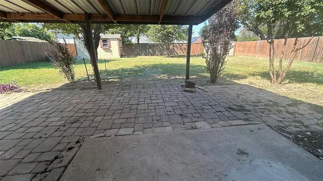 a view of a yard with a tree