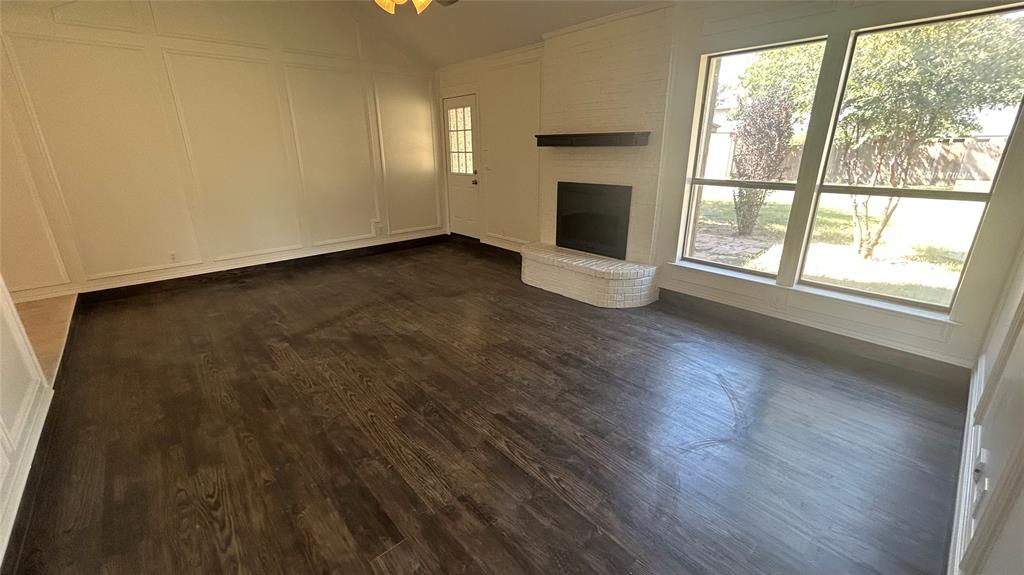 6705 Red Fox Trail Fort Worth, TX 76137 - Photo 4 of 15 a view of an empty room with wooden floor and a window