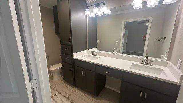 a bathroom with a double vanity sink and a mirror