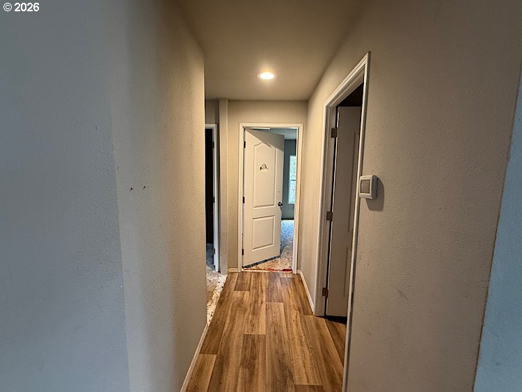 16125 Hawks Lair Road La Pine, OR 97739 - Photo 15 of 35 a view of a hallway with wooden floor and a bathroom