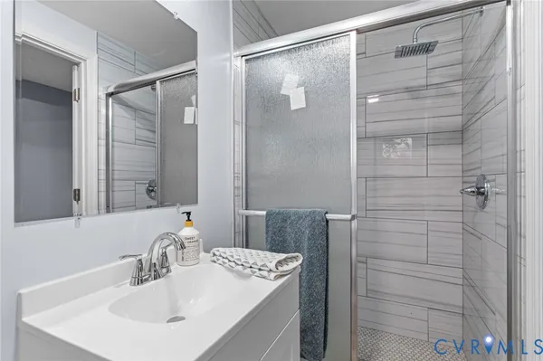 a bathroom with a shower and a sink