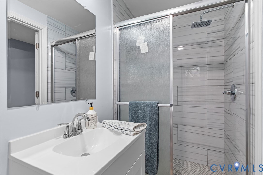 7946 Howerton Road Dunnsville, VA 22454 - Photo 20 of 47 a bathroom with a shower and a sink