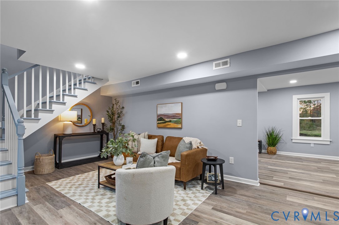 7946 Howerton Road Dunnsville, VA 22454 - Photo 2 of 47 a living room with furniture and a wooden floor