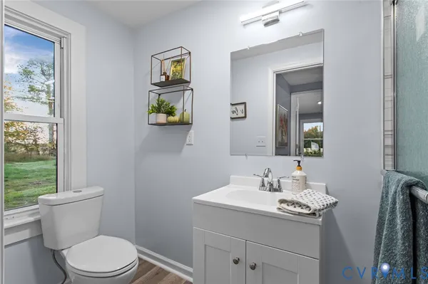 a bathroom with a toilet a sink and mirror