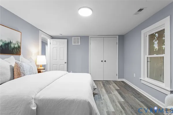 a spacious bedroom with a bed and a window