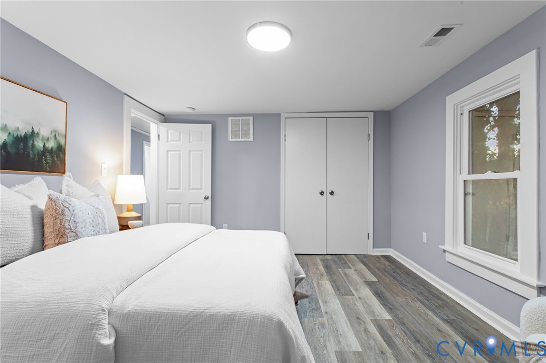 7946 Howerton Road Dunnsville, VA 22454 - Photo 23 of 47 a spacious bedroom with a bed and a window