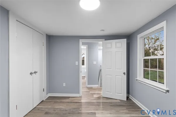 an empty room with windows and closet