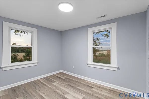 a view of empty room with window and closet