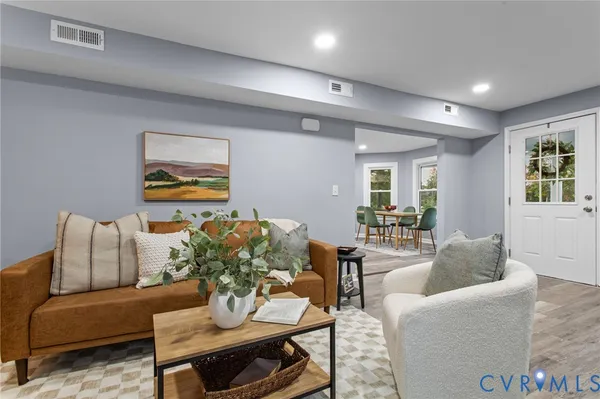 a living room with furniture and painting on the wall