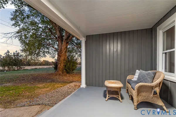 a backyard of a house with table and chairs