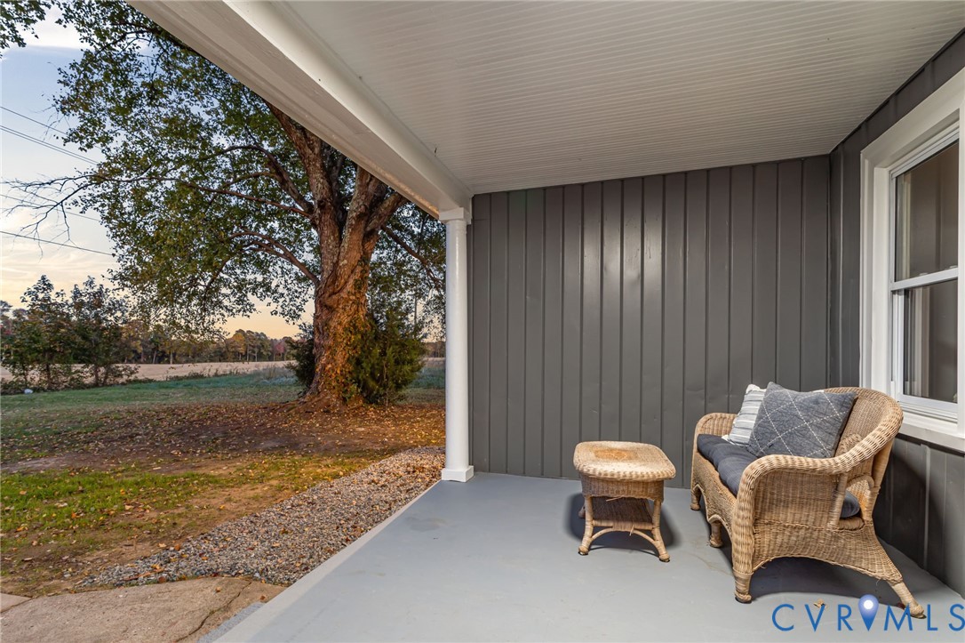 7946 Howerton Road Dunnsville, VA 22454 - Photo 33 of 47 a backyard of a house with table and chairs