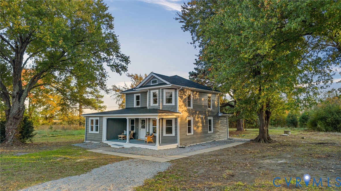 7946 Howerton Road Dunnsville, VA 22454 - Photo 45 of 47 a front view of a house with a garden