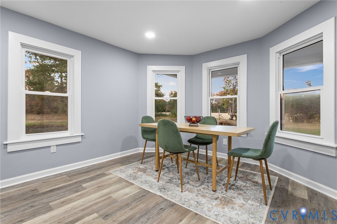 7946 Howerton Road Dunnsville, VA 22454 - Photo 7 of 47 a view of a dining room with furniture window and outside view