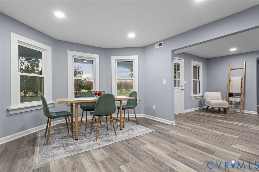7946 Howerton Road Dunnsville, VA 22454 - Photo 9 of 47 a living room with furniture a dining table and a window