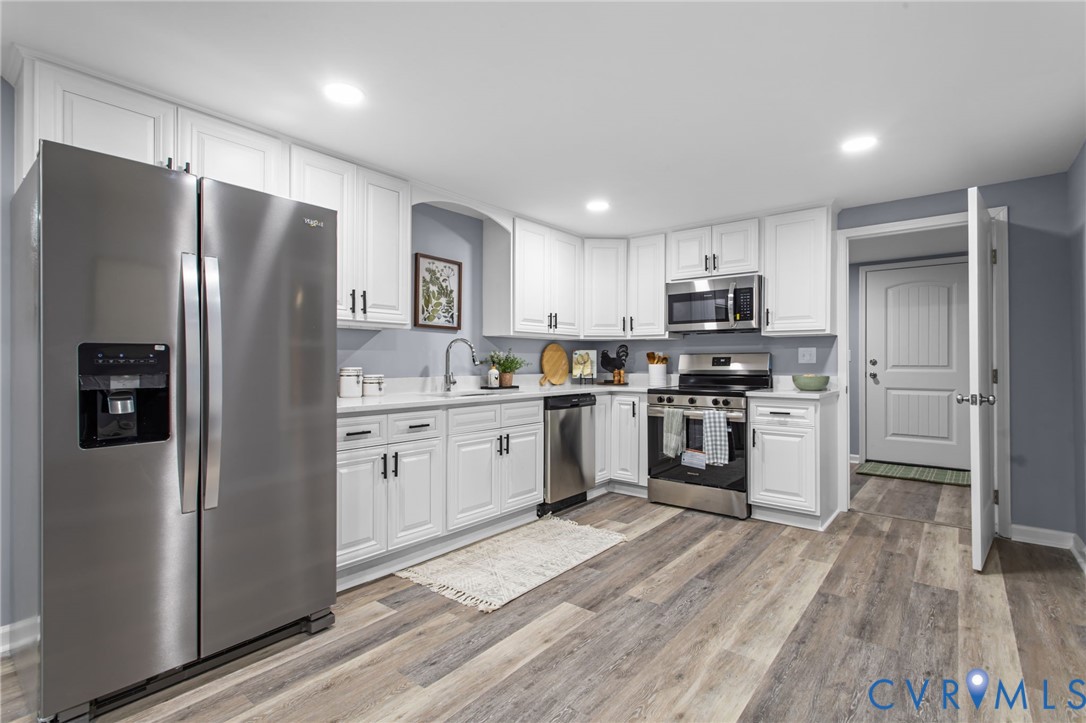 7946 Howerton Road Dunnsville, VA 22454 - Photo 10 of 47 a kitchen with a refrigerator a sink and a stove top oven