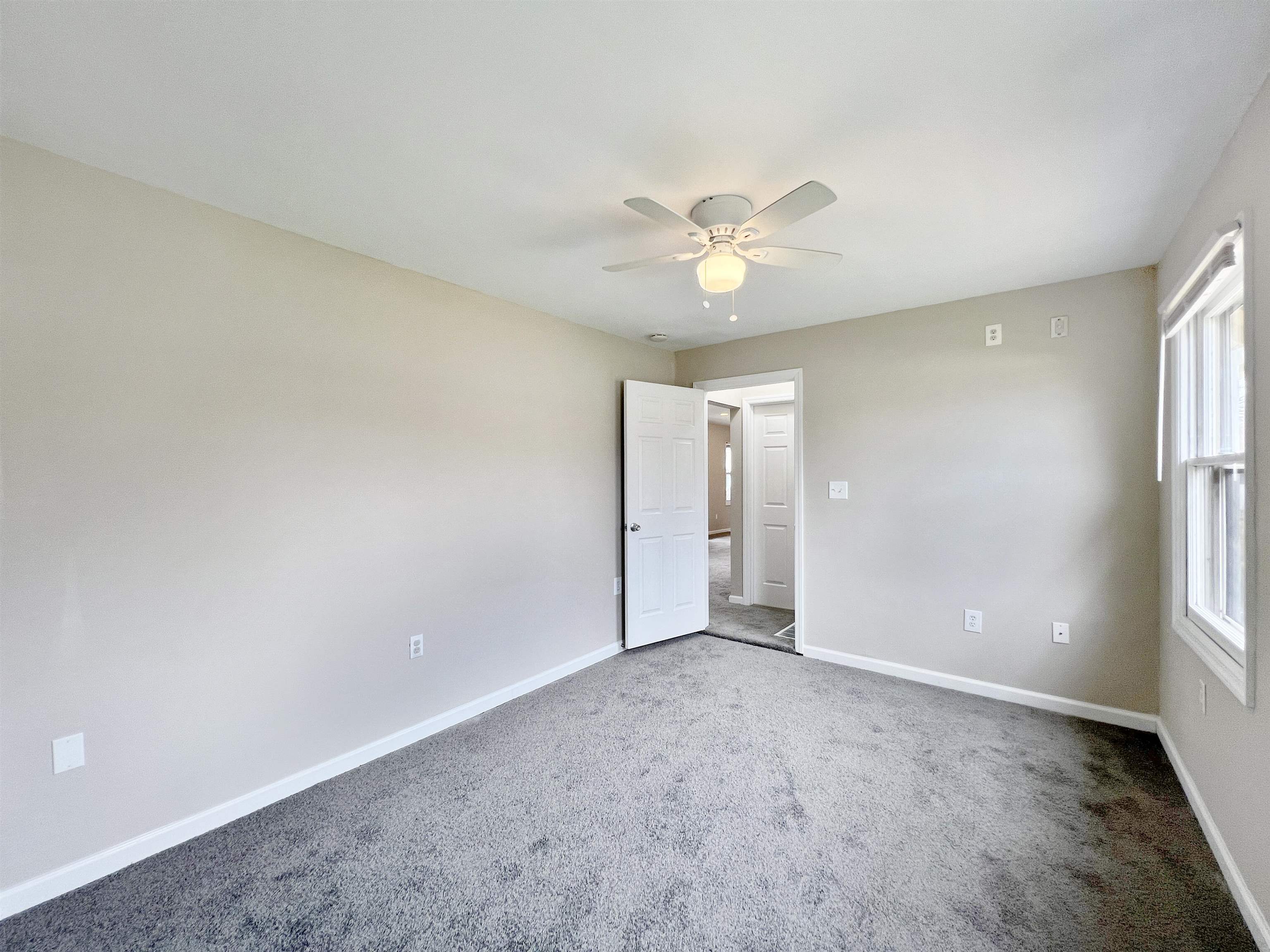 2117 Highway 50 Tuckahoe, NJ 08270 - Photo 13 of 23 an empty room with windows and fan chandelier fan