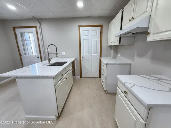 a utility room with cabinets washer and dryer