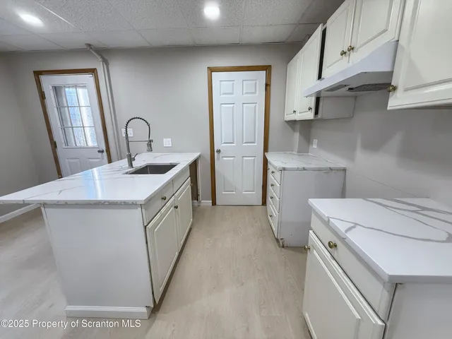 a utility room with cabinets washer and dryer
