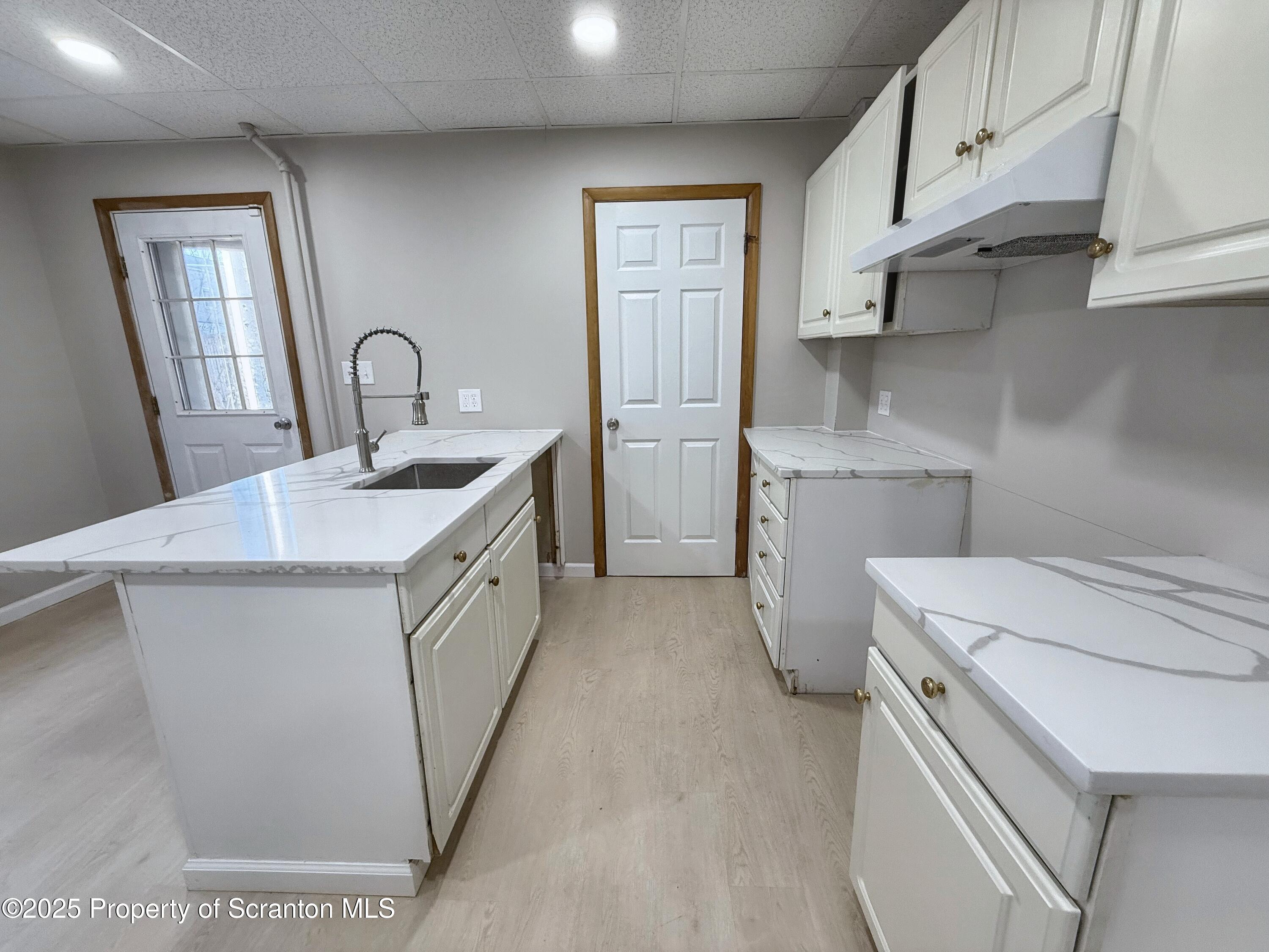 a utility room with cabinets washer and dryer