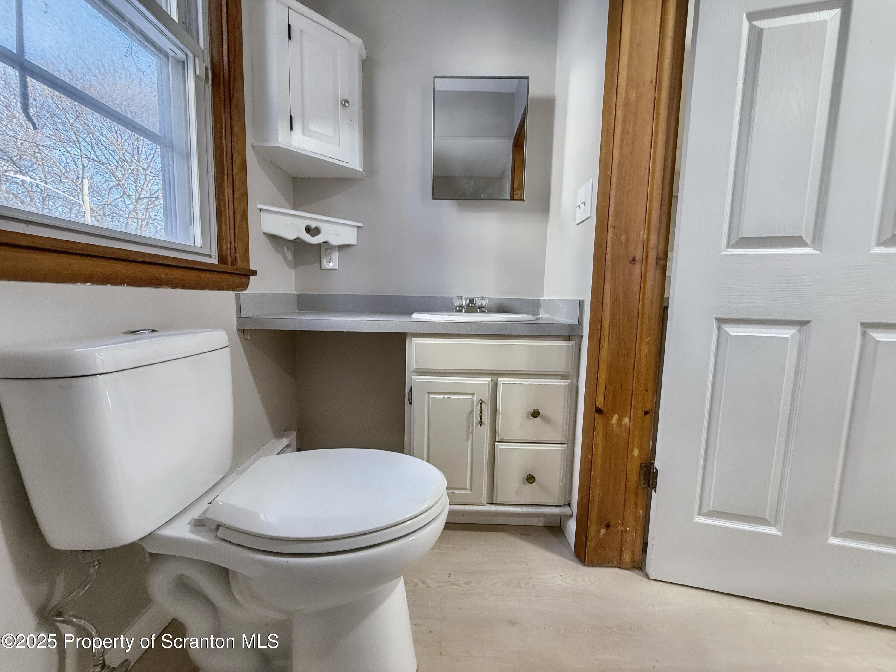 1513 15 Myrtle Street Scranton, PA 18510 - Photo 11 of 22 a bathroom with a toilet sink and mirror