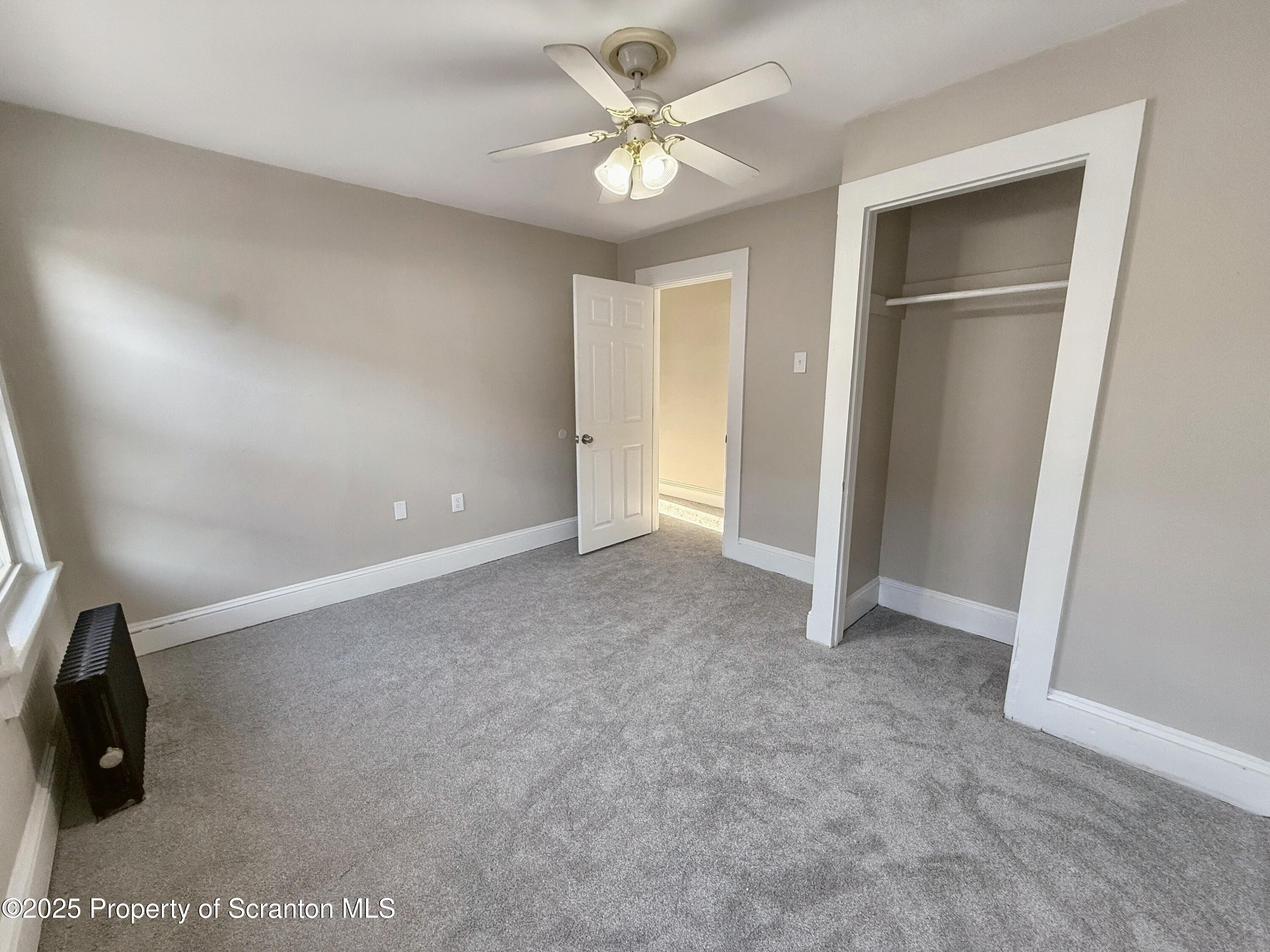 1513 15 Myrtle Street Scranton, PA 18510 - Photo 14 of 22 an empty room with closet and a chandelier fan