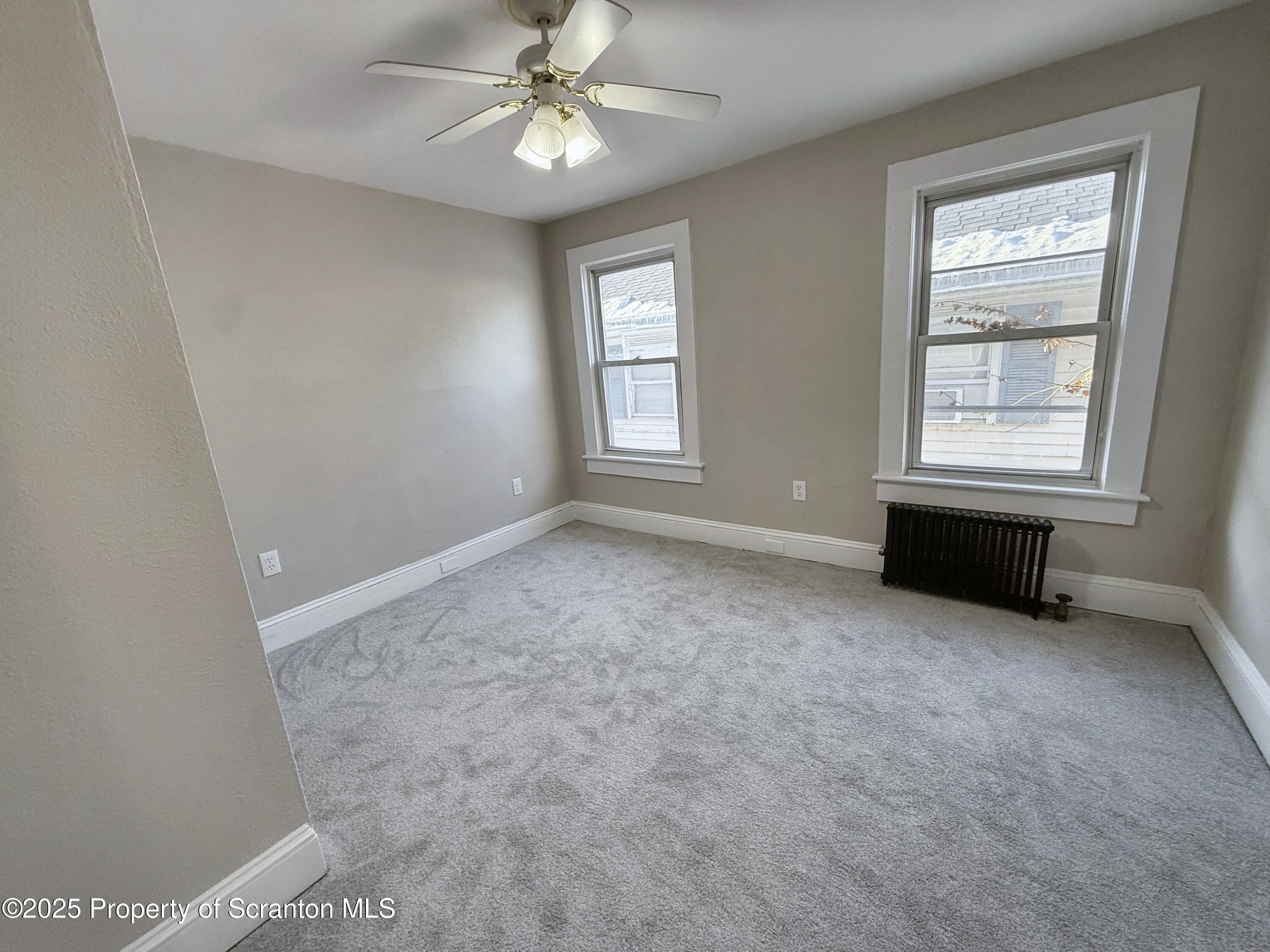 1513 15 Myrtle Street Scranton, PA 18510 - Photo 15 of 22 an empty room with windows and fan