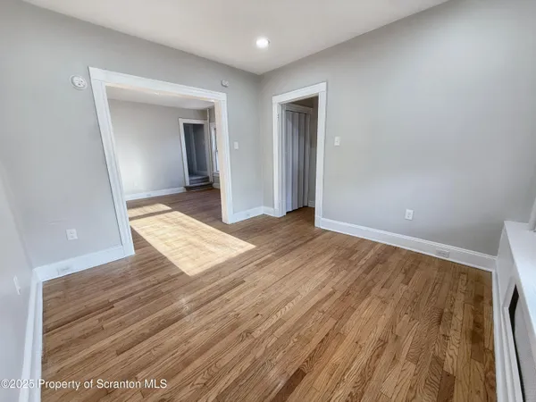 a view of an empty room and wooden floor