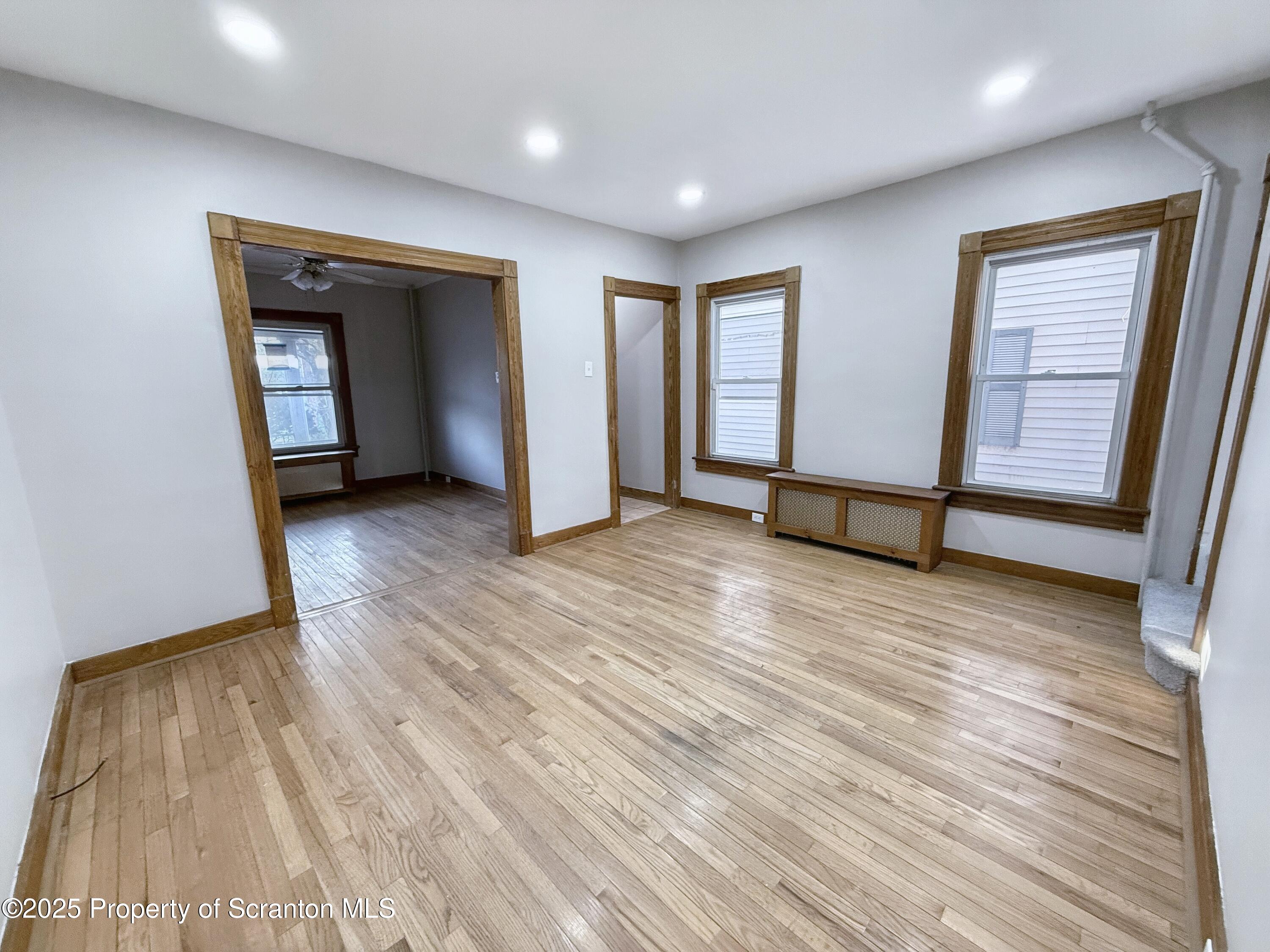 1513 15 Myrtle Street Scranton, PA 18510 - Photo 8 of 22 an empty room with wooden floor and windows
