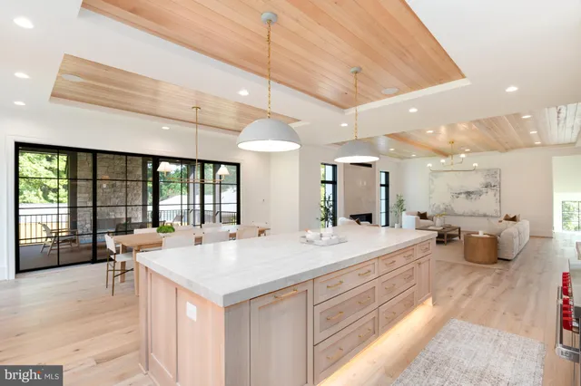 a large white kitchen with a large window