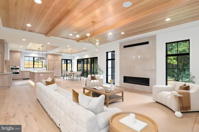 a living room with fireplace furniture and a large window