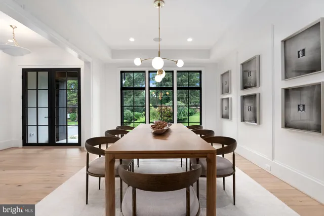 a dining room with furniture window and wooden floor
