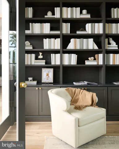 a living room with a couch and a bookshelf