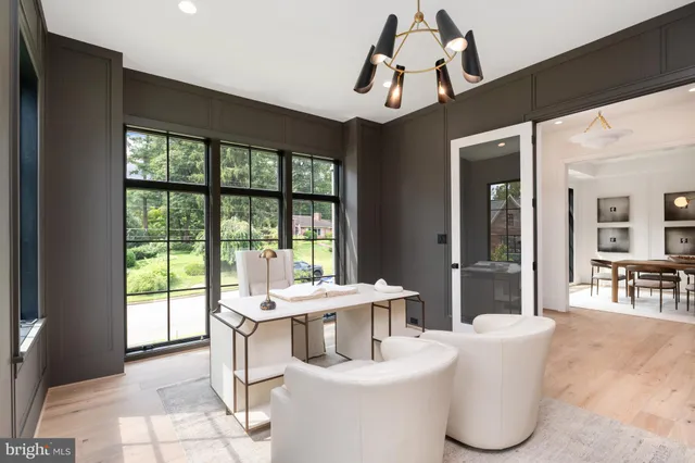 a dining room with furniture a chandelier and wooden floor