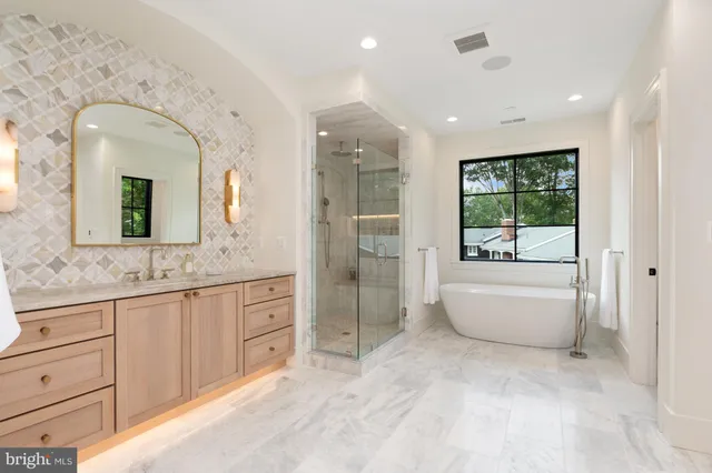 a spacious bathroom with a granite countertop sink mirror and bathtub