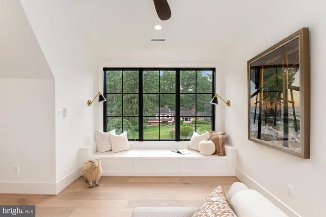 a spacious bedroom with a large bed and a large window