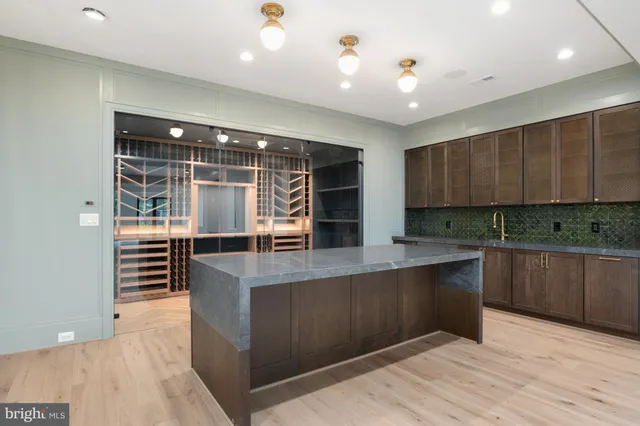 a kitchen with stainless steel appliances granite countertop a stove and cabinets