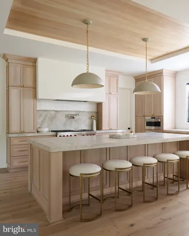 a kitchen with a sink and chairs