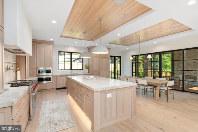 a large white kitchen with a large window