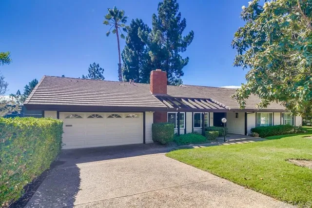 a front view of a house with a yard and outdoor seating