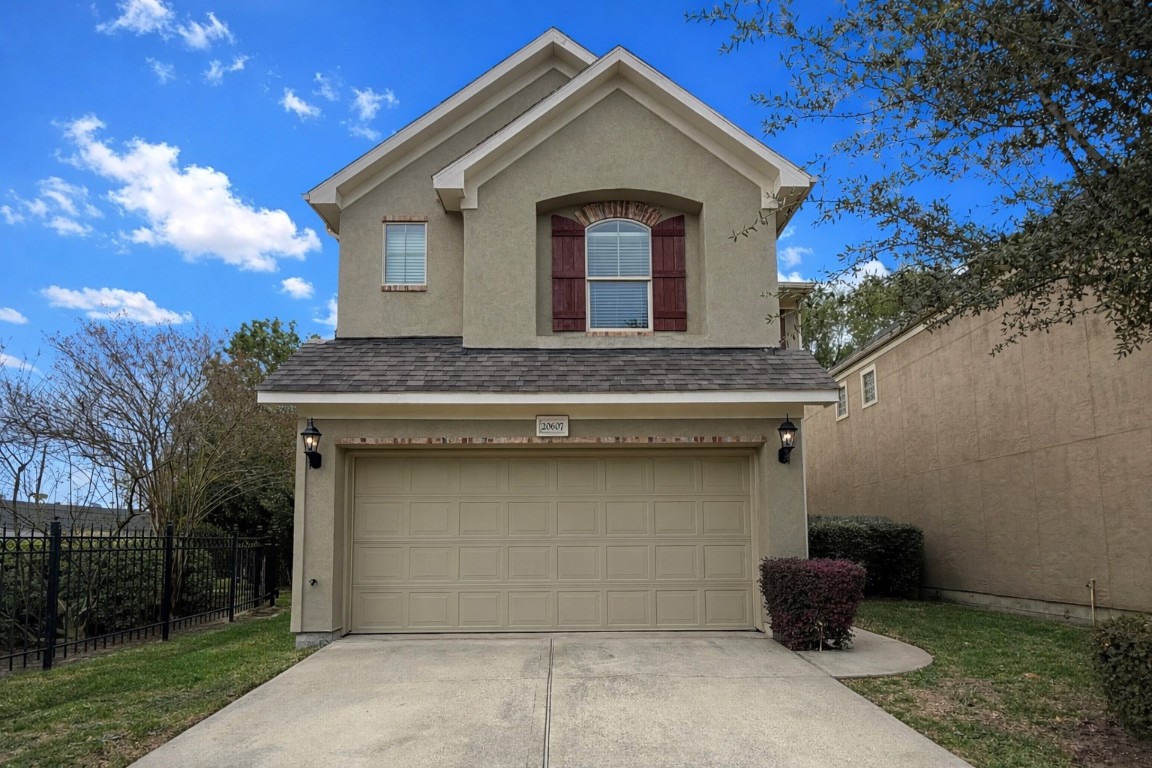 Front exterior elevation showcasing two story design, stucco finish, and attached two car garage.