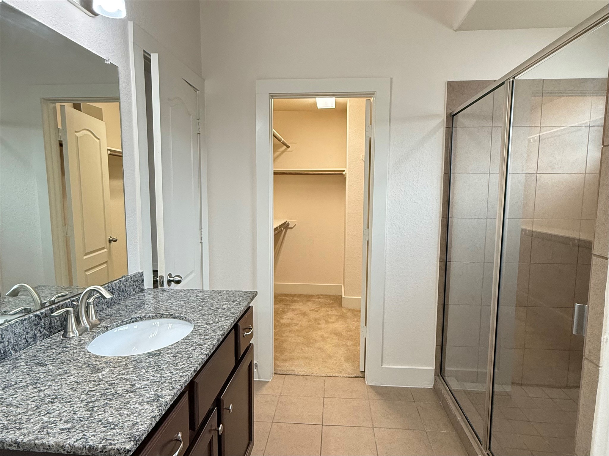 20607 Alfonso Court Spring, TX 77388 - Photo 16 of 26 a bathroom with a granite countertop sink and a mirror