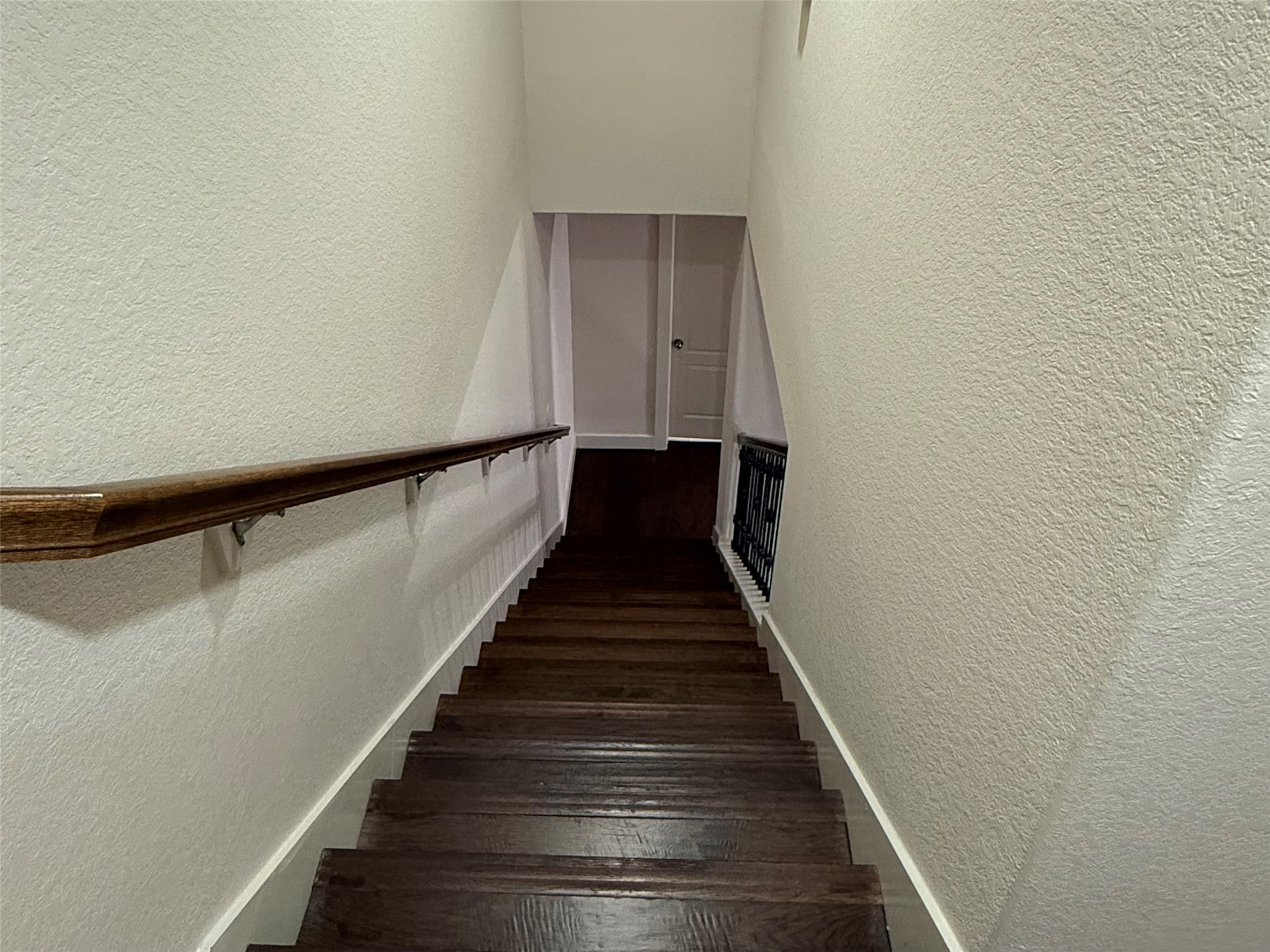 20607 Alfonso Court Spring, TX 77388 - Photo 21 of 25 Stairway with hardwood steps, wood handrail, and wrought iron balusters.