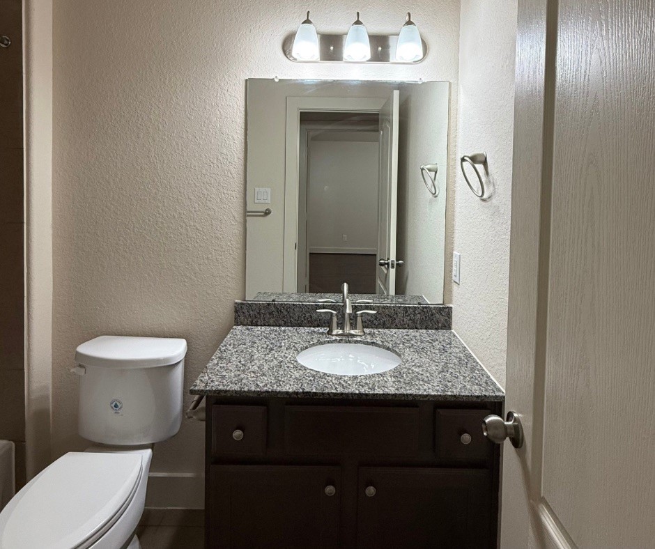 20607 Alfonso Court Spring, TX 77388 - Photo 21 of 26 a bathroom with a granite countertop toilet sink and mirror