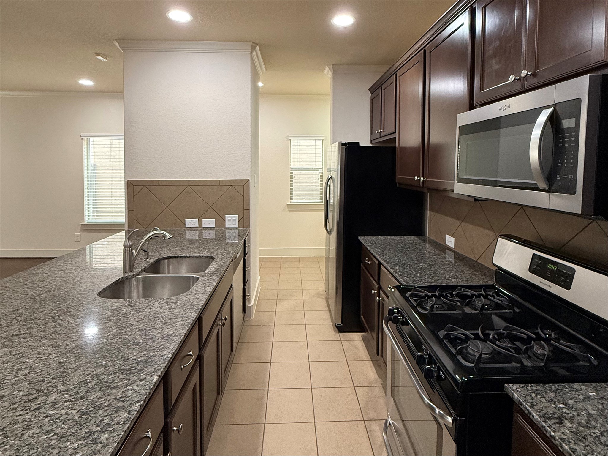 20607 Alfonso Court Spring, TX 77388 - Photo 4 of 25 Alternate kitchen view highlighting center island, double sink, and gas range.